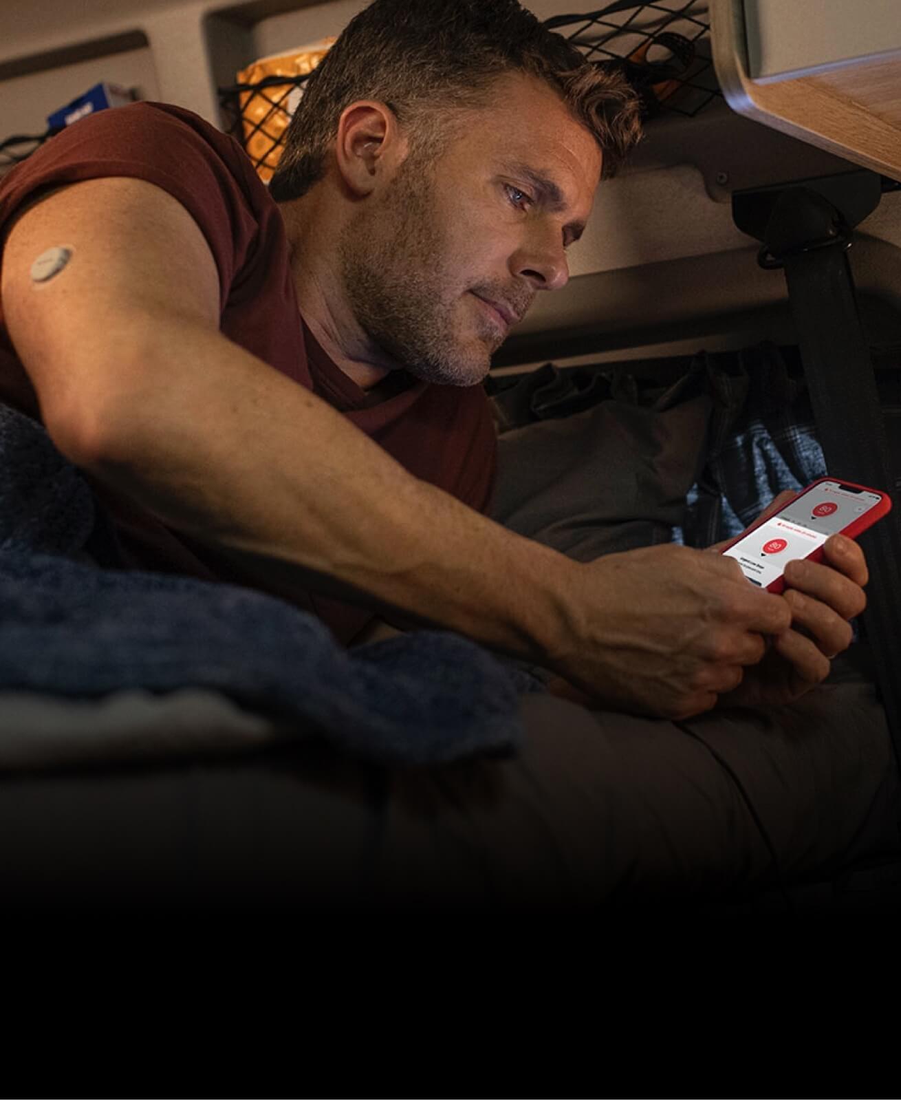 A man checks his alerts on the Dexcom G7 app